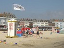 [The Olympic flag flying on Weymouth beach]